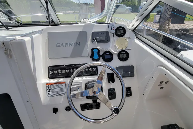 Slide: The Image of 2018 Sea Fox 256 Voyager helm with Garmin navigation system and steering wheel. - 9