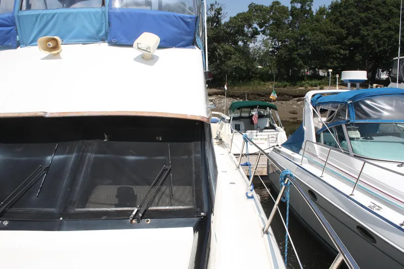 Slide: The Image of 1986 Birchwood 42 Empress yacht docked alongside other boats in a marina. - 11