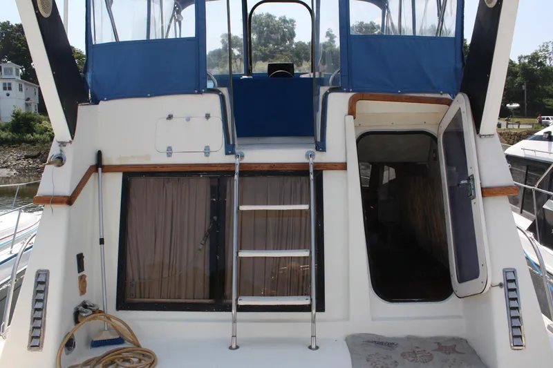 Slide: The Image of 1986 Birchwood 42 Empress yacht stern with ladder and open cabin door. - 15
