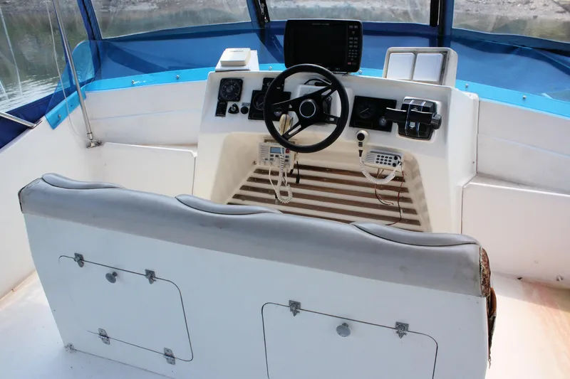 Slide: The Image of Helm of 1986 Birchwood 42 Empress boat with steering wheel and navigation equipment. - 19