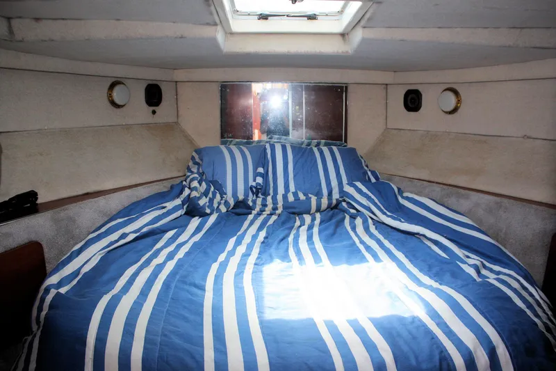 Slide: The Image of Cozy cabin interior of 1986 Birchwood 42 Empress with striped bedding. - 22
