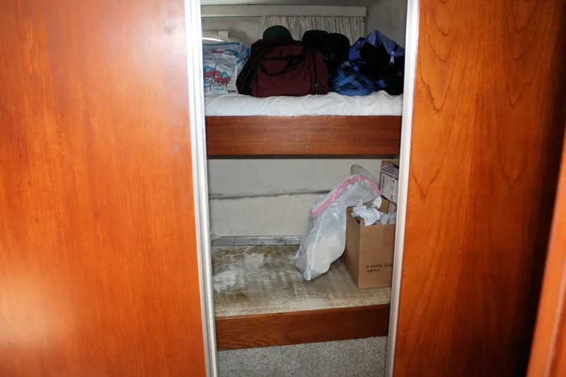 Slide: The Image of Interior storage space on a 1986 Birchwood 42 Empress boat with shelves and bags. - 26