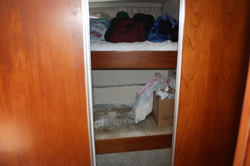 Slide: The Image of Interior storage space in a 1986 Birchwood 42 Empress boat with wooden shelves. - 27