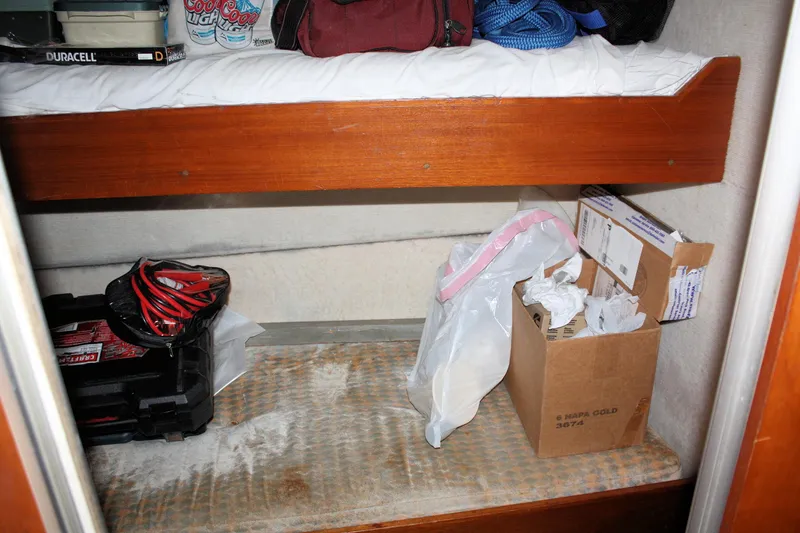 Slide: The Image of Storage area inside 1986 Birchwood 42 Empress boat with various items and supplies. - 28