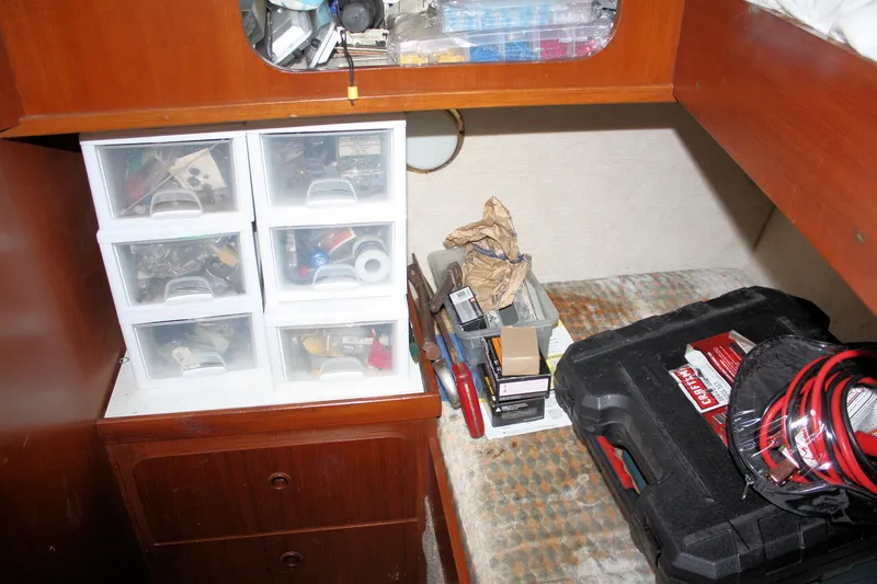 Slide: The Image of Storage area inside a 1986 Birchwood 42 Empress boat with tools and supplies. - 29