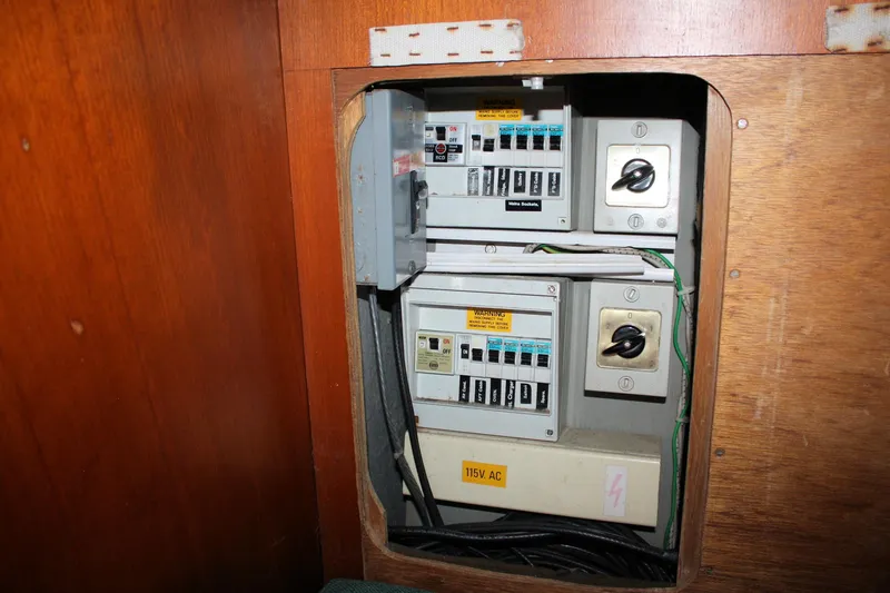 Slide: The Image of Electrical panel inside 1986 Birchwood 42 Empress boat, featuring switches and wiring. - 33