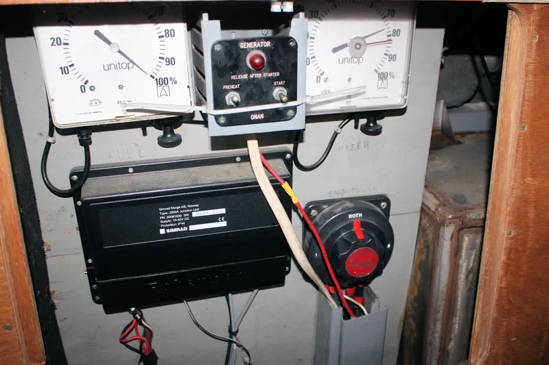 Slide: The Image of Electrical panel of a 1986 Birchwood 42 Empress boat, featuring gauges and wiring. - 34
