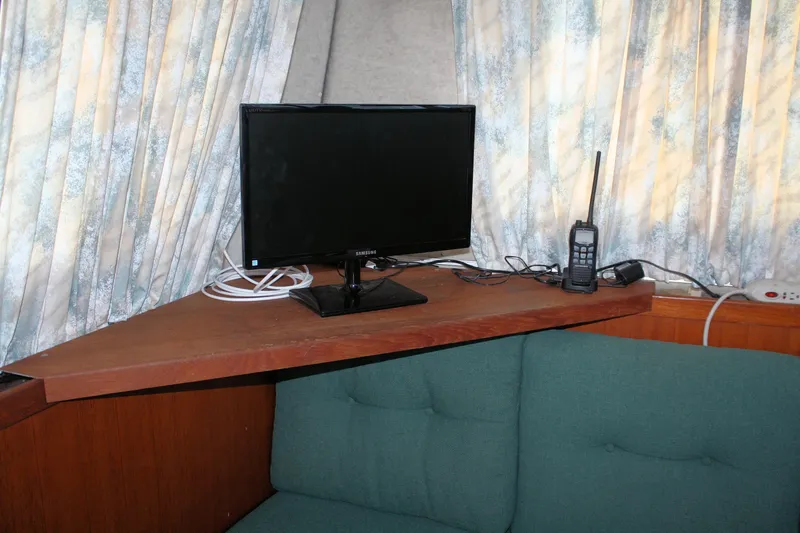 Slide: The Image of Interior of 1986 Birchwood 42 Empress with TV and radio on wooden shelf. - 35