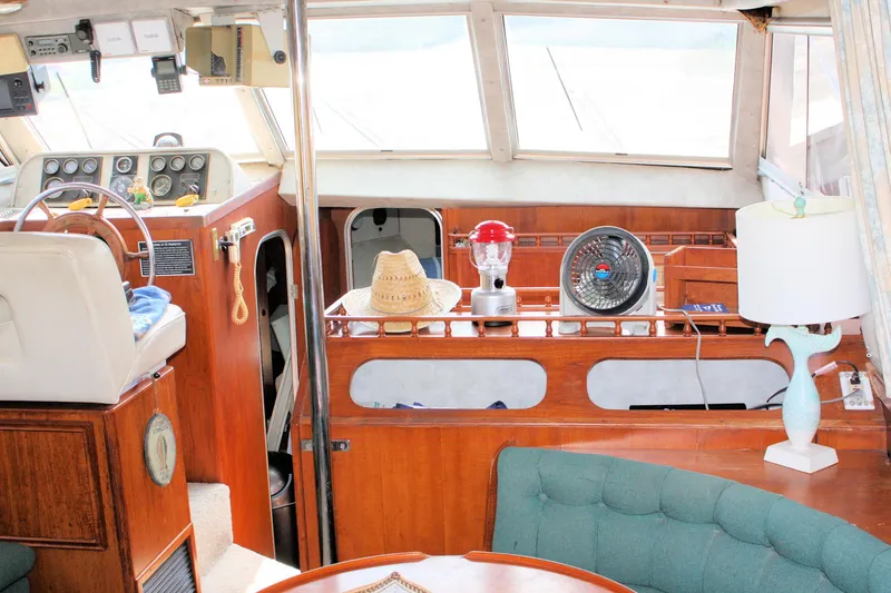 Slide: The Image of Interior of 1986 Birchwood 42 Empress yacht with helm, seating, and decor items. - 44