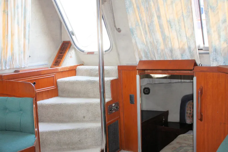 Slide: The Image of Interior of 1986 Birchwood 42 Empress yacht with stairs and wooden accents. - 47