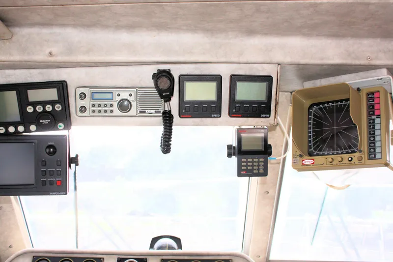 Slide: The Image of Control panel of a 1986 Birchwood 42 Empress boat with navigation equipment. - 49