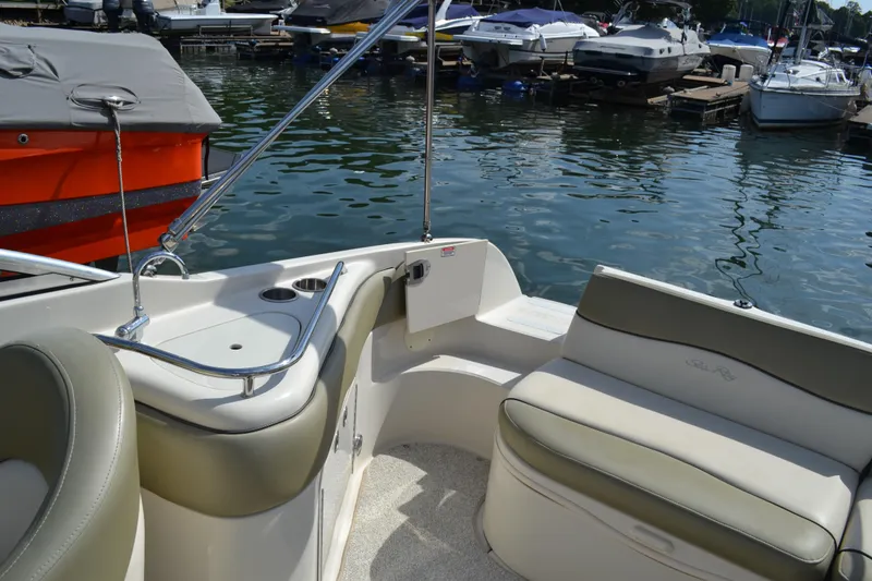 Slide: The Image of 2005 Sea Ray 240 Sundeck interior with seating and lake view. - 11