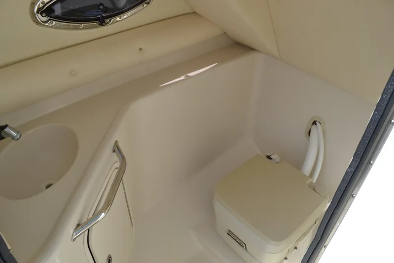 Slide: The Image of 2005 Sea Ray 240 Sundeck boat interior bathroom with sink and portable toilet. - 13