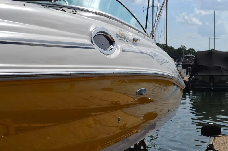 Slide: The Image of 2005 Sea Ray 240 Sundeck boat docked at a marina. - 17