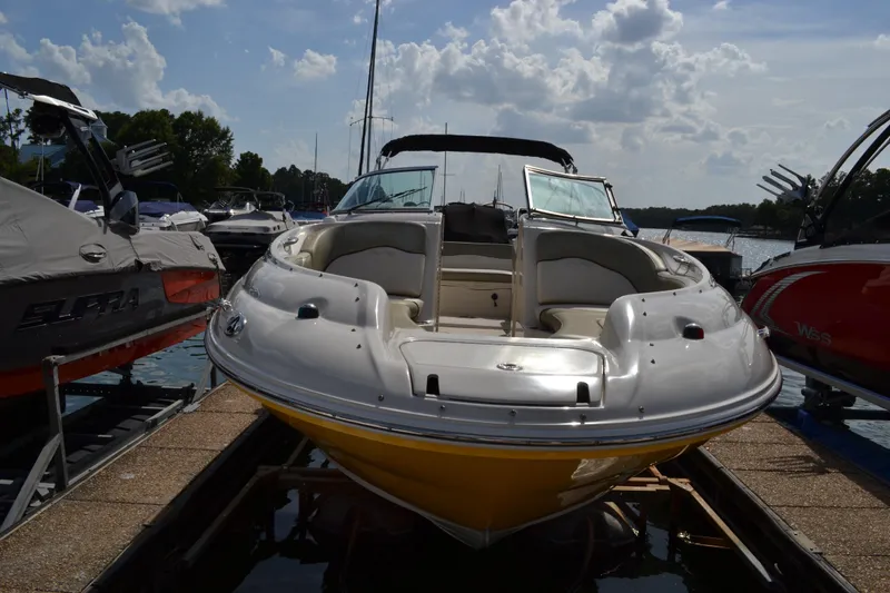 Slide: The Image of 2005 Sea Ray 240 Sundeck boat docked at marina. - 2
