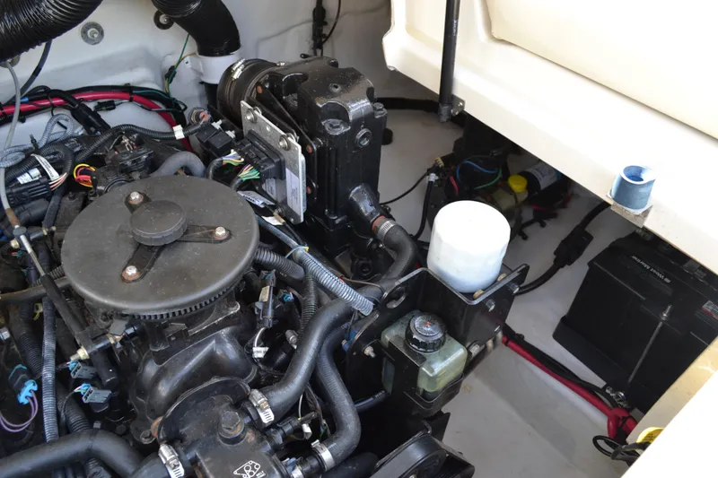 Slide: The Image of Engine compartment of a 2005 Sea Ray 240 Sundeck boat showing various components and wiring. - 20