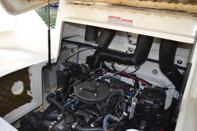Slide: The Image of 2005 Sea Ray 240 Sundeck engine compartment with visible components and wiring. - 22