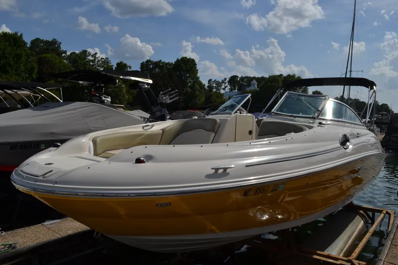 Slide: The Image of 2005 Sea Ray 240 Sundeck boat docked on a sunny day. - 3