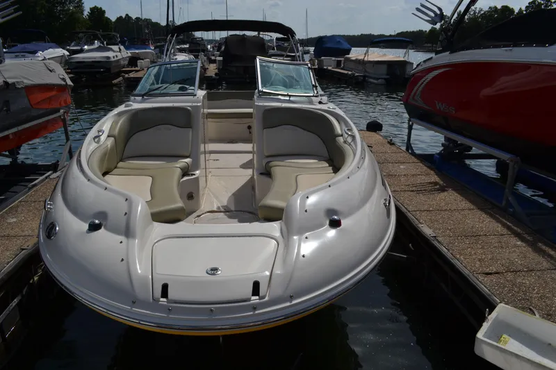 Slide: The Image of 2005 Sea Ray 240 Sundeck boat docked at a marina. - 4