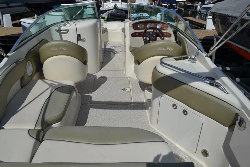 Slide: The Image of 2005 Sea Ray 240 Sundeck boat interior with beige and green seating. - 6
