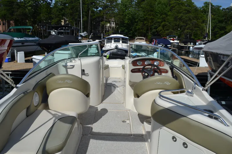 Slide: The Image of 2005 Sea Ray 240 Sundeck boat interior with seating and steering wheel. - 7