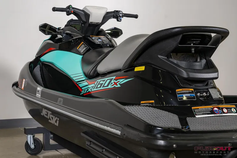 Slide: The Image of 2020 Kawasaki STX 160X jet ski in black and teal, rear view. - 10