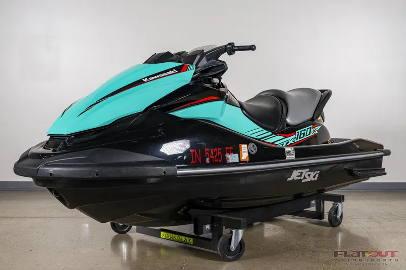 Slide: The Image of 2020 Kawasaki STX 160X jet ski in teal and black on display. - 4