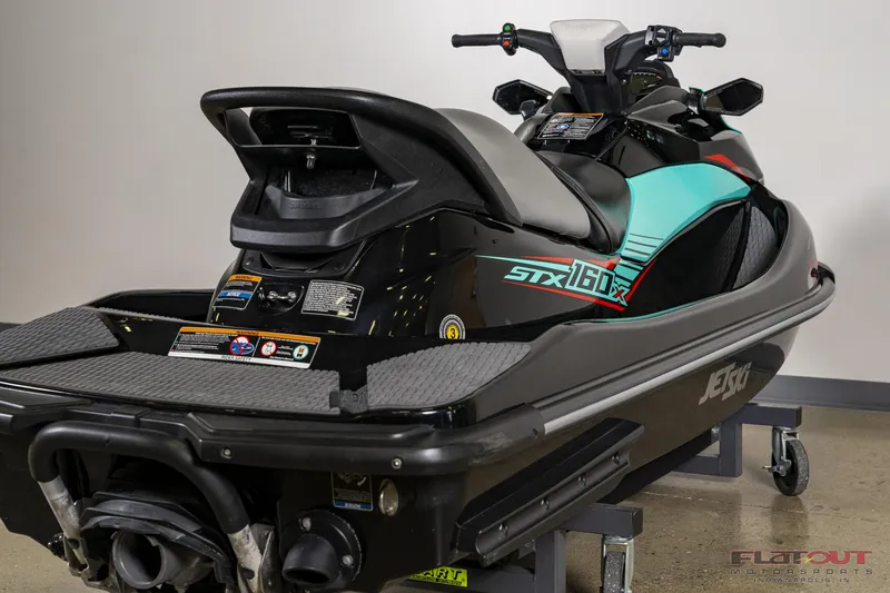 Slide: The Image of 2020 Kawasaki STX 160X jet ski, rear view, black and teal design. - 9