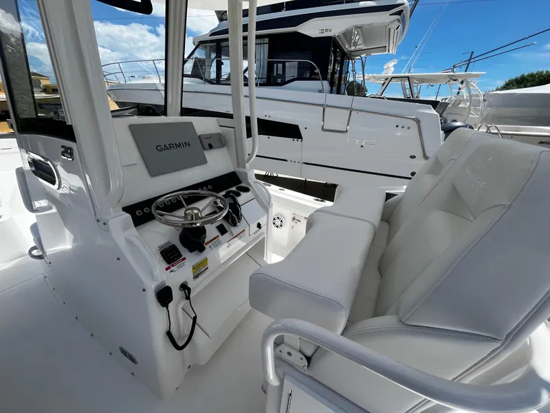 Slide: The Image of 2025 Regulator 23 boat interior with Garmin navigation system and white seating. - 13