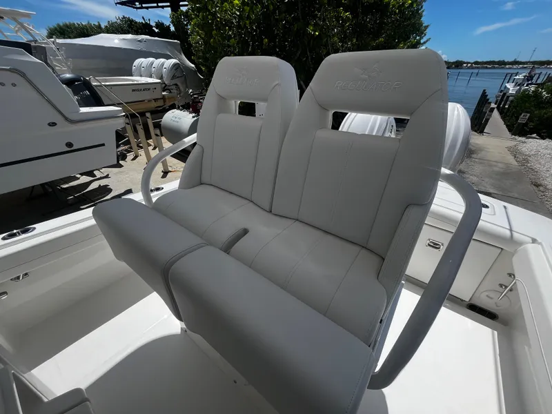 Slide: The Image of 2025 Regulator 23 boat with dual cushioned seats at the helm. - 14