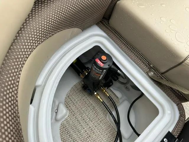 Slide: The Image of 2024 Regency 230 DL3 boat storage compartment with pump and wiring. - 11