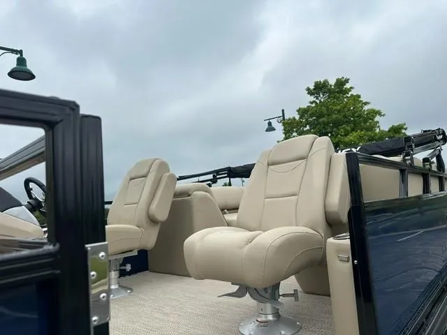 Slide: The Image of 2024 Regency 230 DL3 boat with beige seating and sleek design. - 6