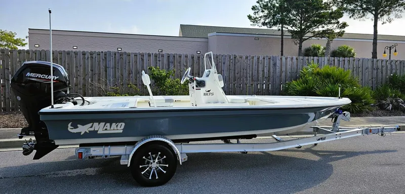 Slide: The Image of 2024 Mako 18 LTS boat on trailer, parked outdoors. - 0