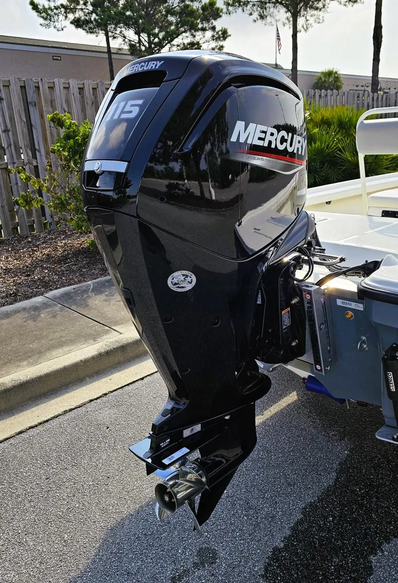 Slide: The Image of 2024 Mako 18 LTS boat with Mercury outboard motor in a parking lot. - 5