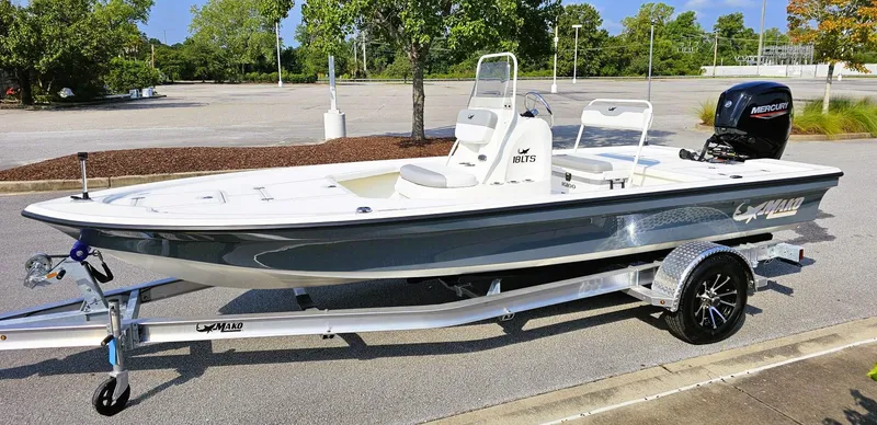 Slide: The Image of 2024 Mako 18 LTS boat on trailer in parking lot, side view. - 7