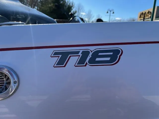 Slide: The Image of 2024 Tahoe T18 boat logo on white surface with red stripe. - 4