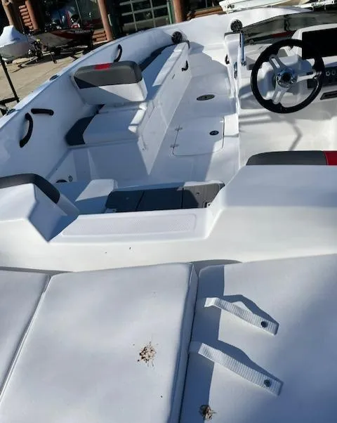 Slide: The Image of 2024 Tahoe T18 boat interior with white seating and steering wheel. - 5