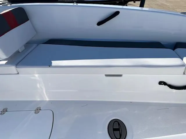 Slide: The Image of 2024 Tahoe T18 boat interior with white seating and storage compartment. - 6