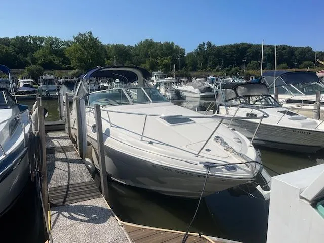Slide: The Image of 2005 Sea Ray 280 Sundancer docked at a marina on a sunny day. - 1
