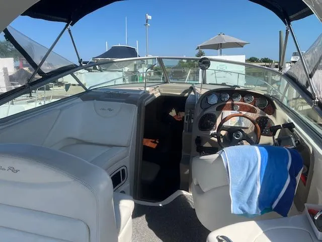 Slide: The Image of 2005 Sea Ray 280 Sundancer boat interior with helm and seating area. - 11