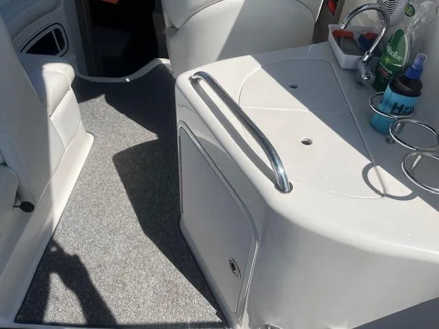 Slide: The Image of Interior of 2005 Sea Ray 280 Sundancer boat with kitchenette and seating area. - 12