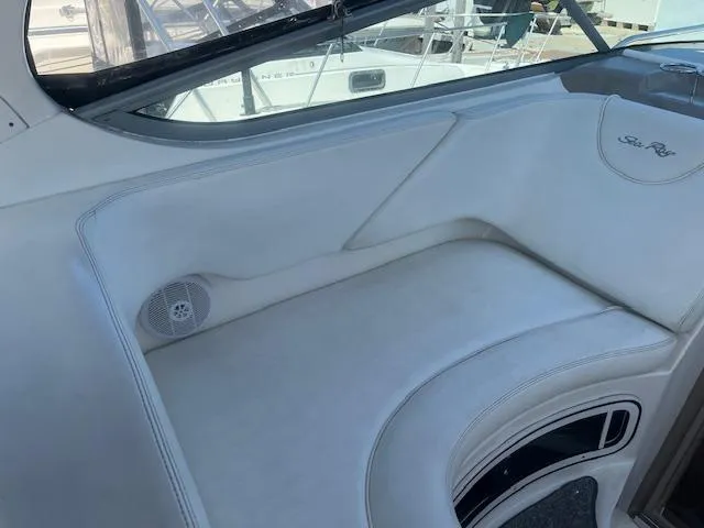 Slide: The Image of 2005 Sea Ray 280 Sundancer interior seating area with white upholstery. - 14