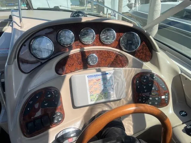 Slide: The Image of 2005 Sea Ray 280 Sundancer dashboard with gauges and controls. - 16