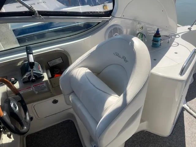 Slide: The Image of 2005 Sea Ray 280 Sundancer cockpit with steering wheel and captain's chair. - 17