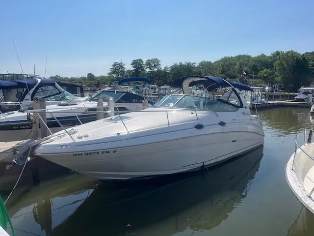 Slide: The Image of 2005 Sea Ray 280 Sundancer docked at a marina on a sunny day. - 2