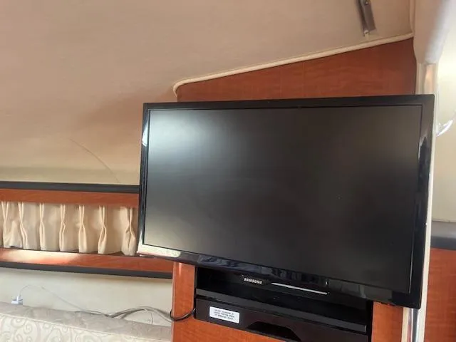 Slide: The Image of Flat-screen TV in the cabin of a 2005 Sea Ray 280 Sundancer boat. - 23