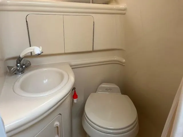 Slide: The Image of Compact bathroom in 2005 Sea Ray 280 Sundancer boat with sink and toilet. - 25