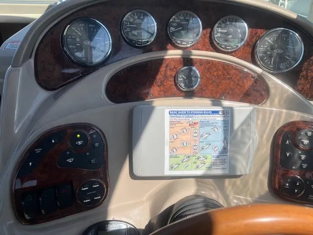 Slide: The Image of Dashboard of a 2005 Sea Ray 280 Sundancer boat with gauges and navigation screen. - 28