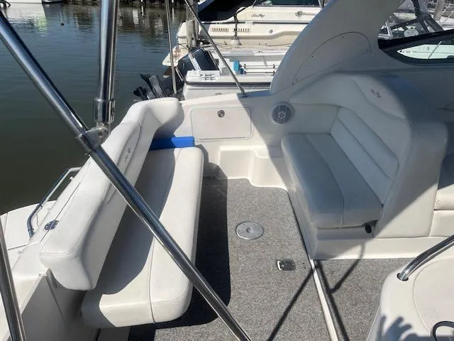 Slide: The Image of 2005 Sea Ray 280 Sundancer boat interior with white seating and carpeted floor. - 4