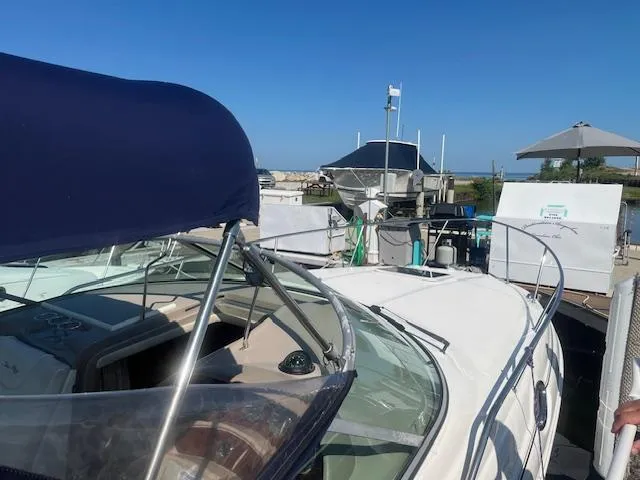 Slide: The Image of 2005 Sea Ray 280 Sundancer boat docked at a marina on a sunny day. - 5